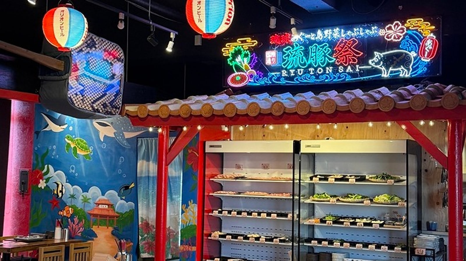 琉豚祭のネオン看板と沖縄らしい壁画のある店頭